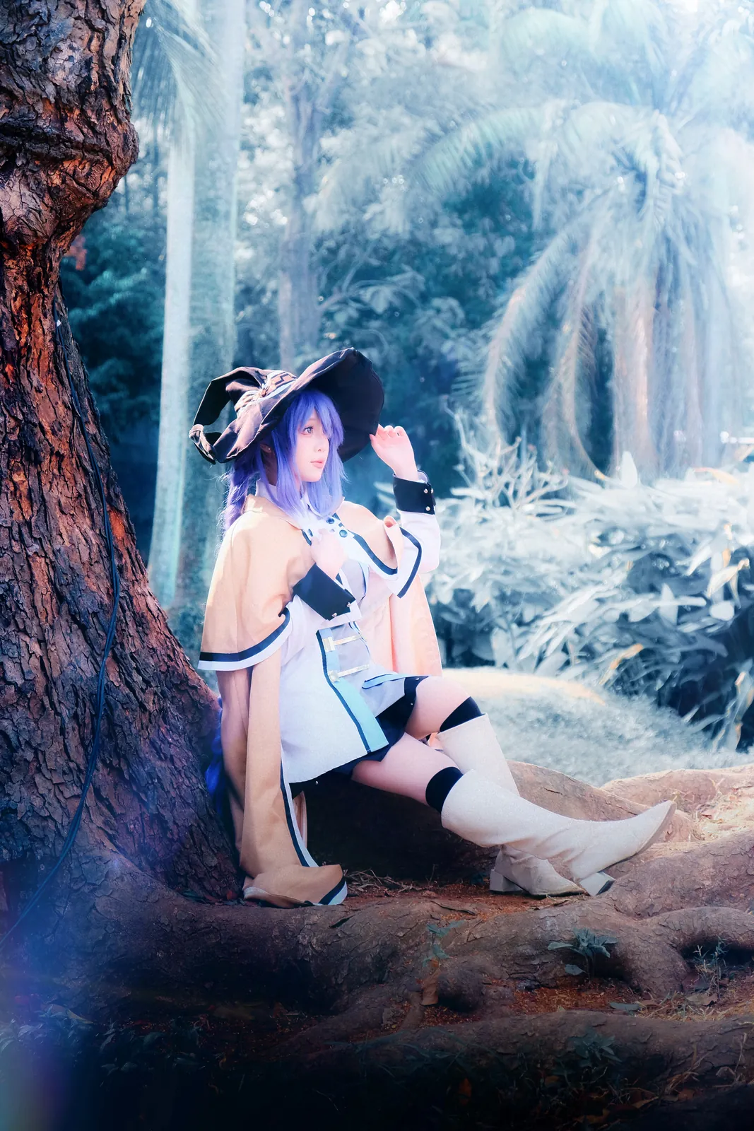 Roxy Migurdia cosplay seated beneath a tree
