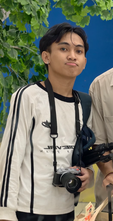Iki, the photographer behind Lowkeyiki, holding his camera