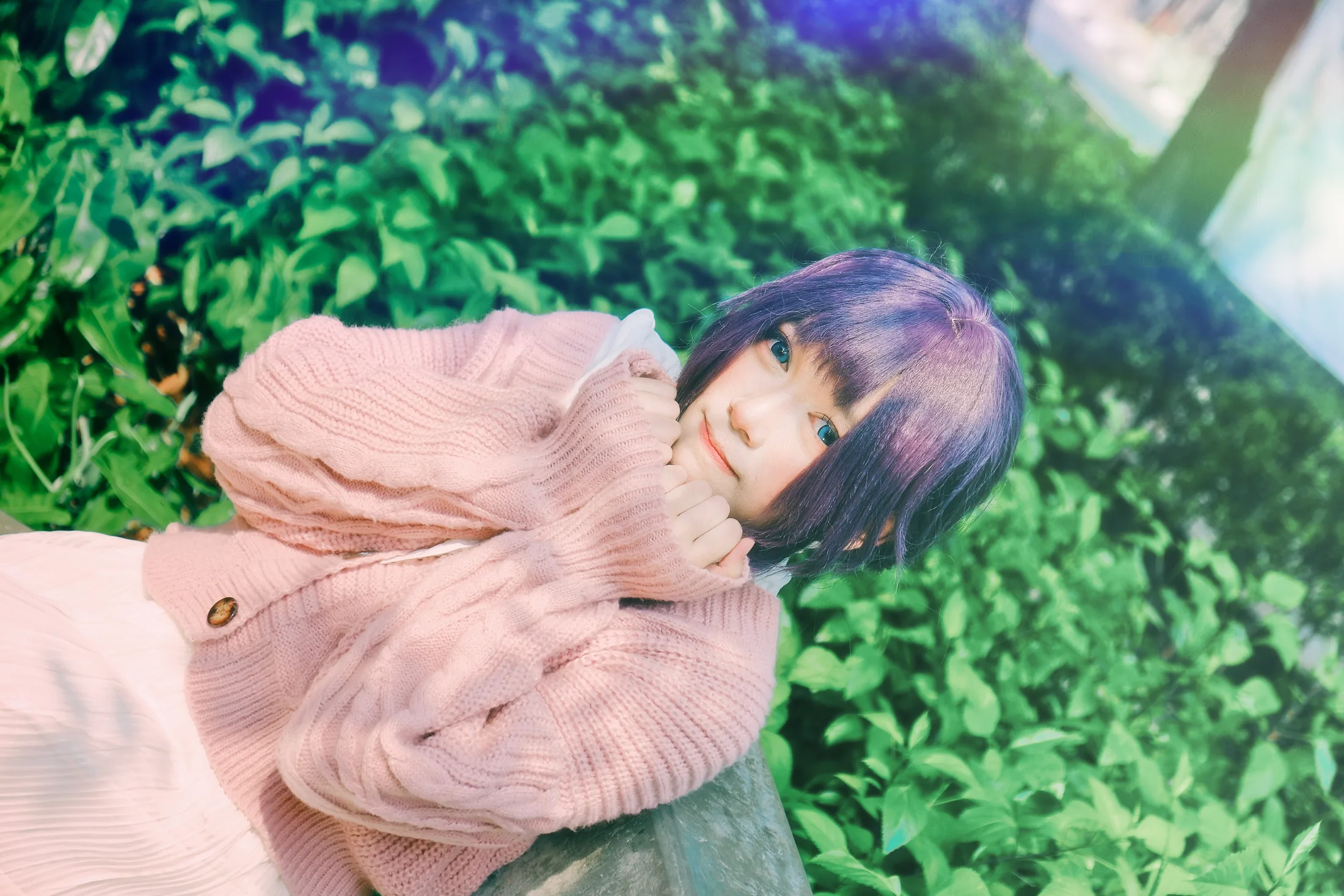 Waguri portrait reclining beside green foliage