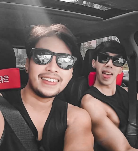 Nino and a friend inside a car
